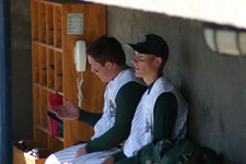 Curtis Porter and Brian Chatterton sit in dugout after scoring