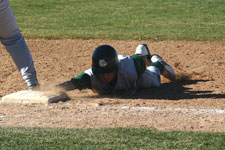 Brian Chatterton dives back to first base and averts the tag