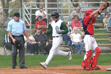 Andrew Law steps on home plate