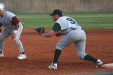 Clint Phillips holds the runner on first base