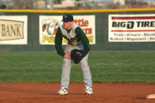 Andrew Law stands behind runner at second base