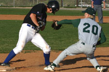 Shawn Stinson applies tag to baserunner at first
