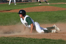 Clint Phillips dives safely back to the first base bag