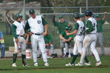 Coach Moore talks to Bryce Ayoso and baserunners