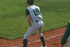 Dustin Migliaccio stands on third base next to head coach Lance Moore