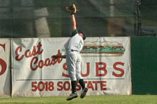 Austin Rowberry makes an attempt at a high shot in deep left field