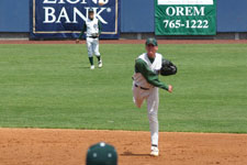 Andrew Law throws to first base